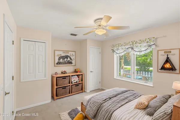 a kitchen that has a sink and white cabinets with chairs