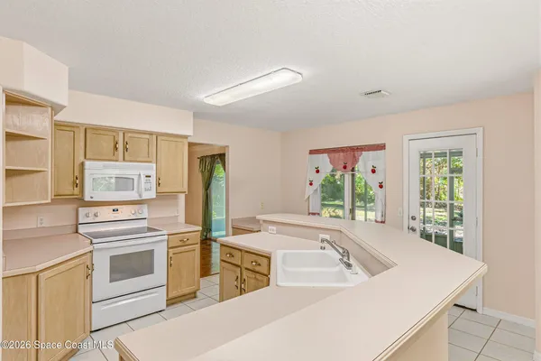 a kitchen with a cabinets and a stove top oven
