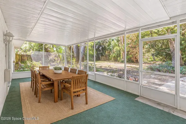 a backyard of a house with table and chairs