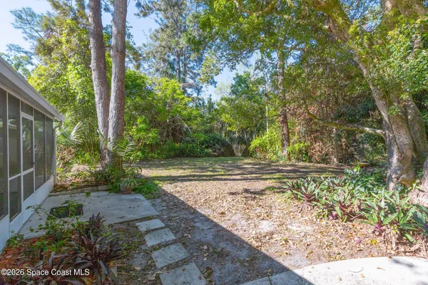 a view of house with backyard and sitting area