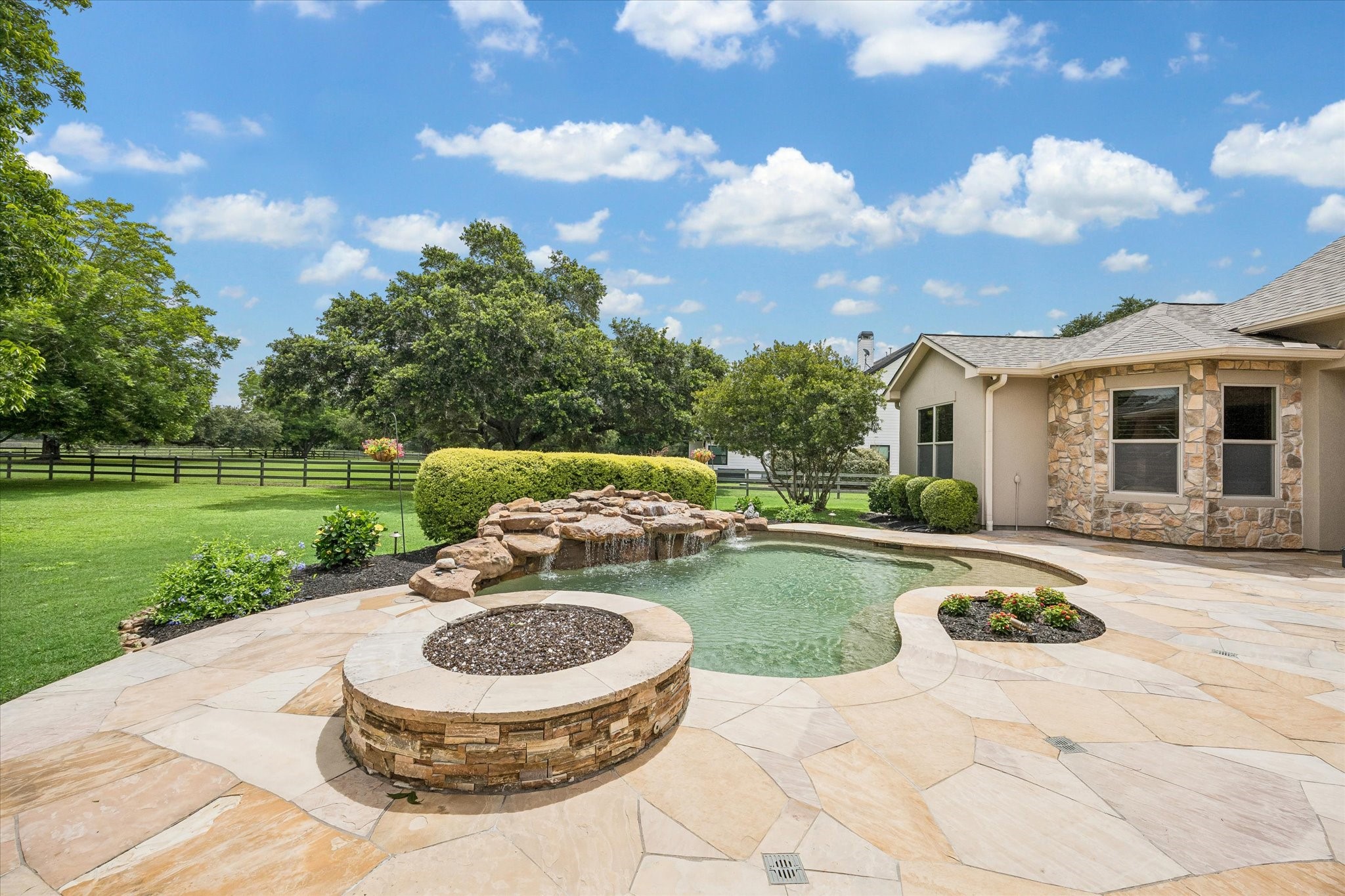 32102 Fulbrook Commons Fulshear, TX 77441 - Photo 38 of 50 Surrounded by mature trees and open green space, the pool area feels private, peaceful, and designed for both recreation and relaxation.