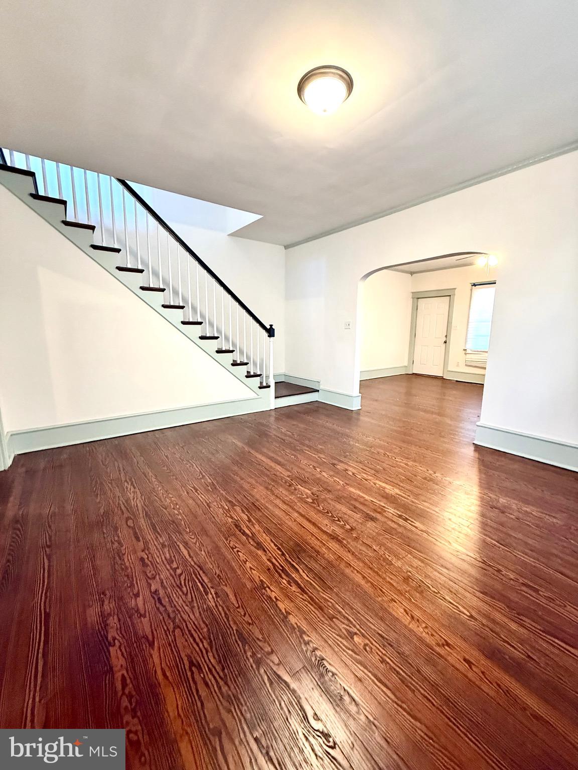 109-111 State Street Penns Grove, NJ 08069 - Photo 1 of 20 a view of an empty room with wooden floor and stairs