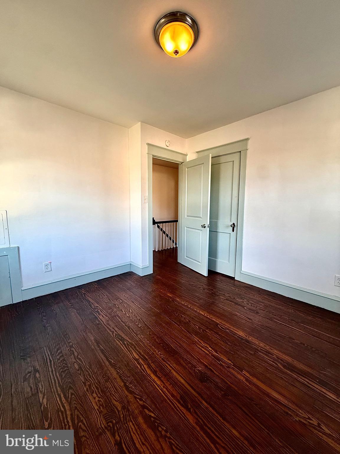 109-111 State Street Penns Grove, NJ 08069 - Photo 13 of 20 a view of an empty room with wooden floor and window