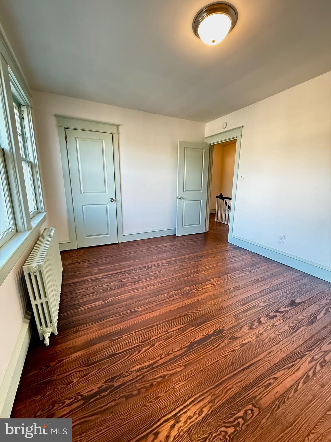 109-111 State Street Penns Grove, NJ 08069 - Photo 16 of 20 a view of an empty room with wooden floor and a window