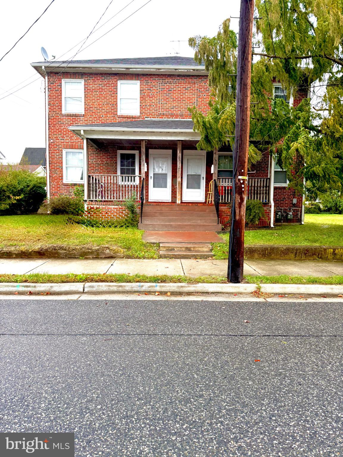 109-111 State Street Penns Grove, NJ 08069 - Photo 20 of 20 a front view of a house with a yard and garage
