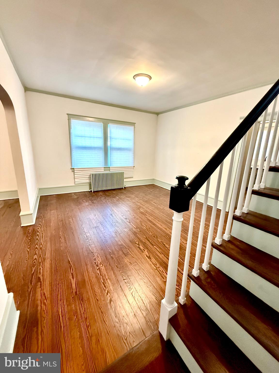109-111 State Street Penns Grove, NJ 08069 - Photo 4 of 20 a view of an empty room with wooden floor and stairs