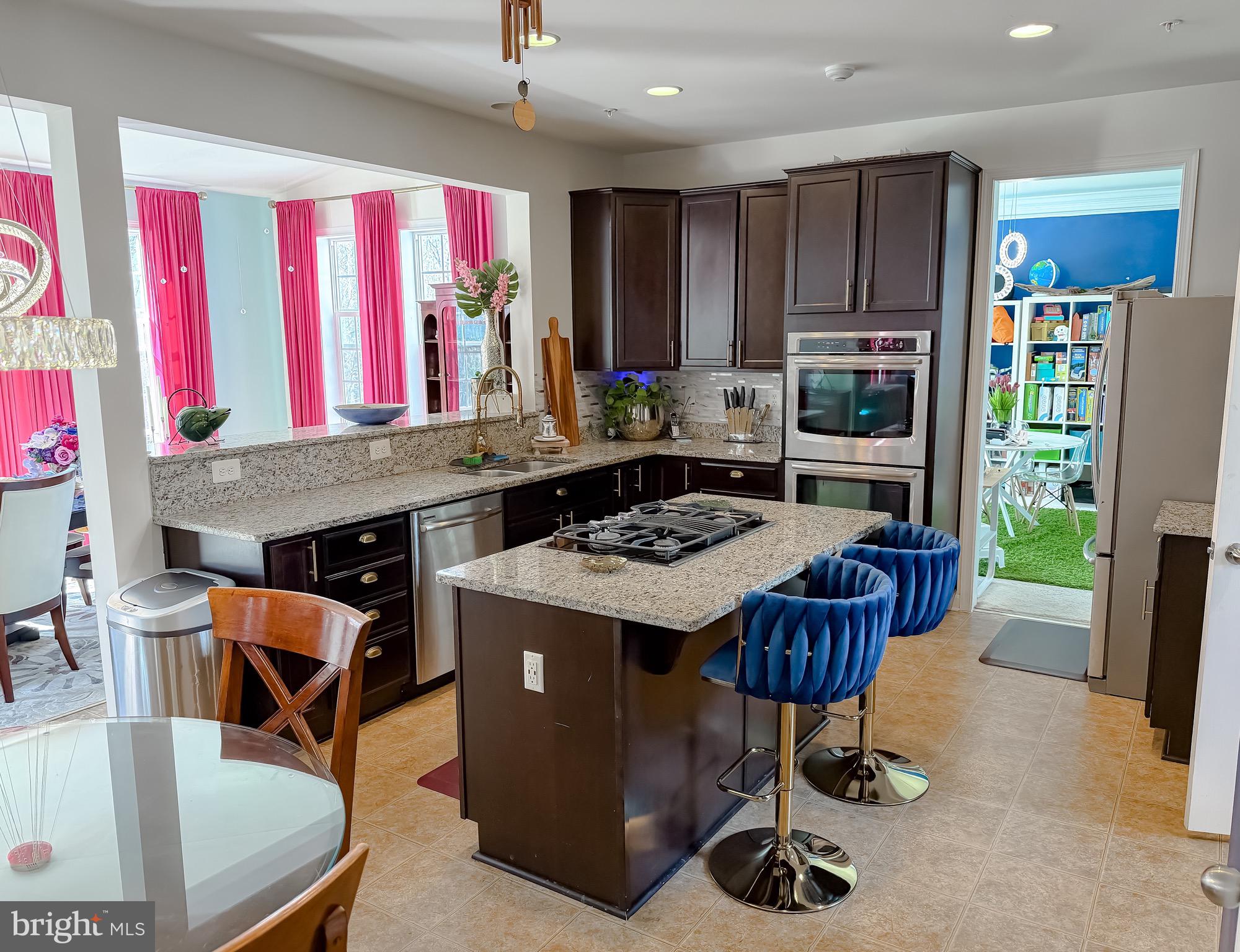 2810 Pumpkin Street Clinton, MD 20735 - Photo 11 of 27 a kitchen with stainless steel appliances granite countertop a stove a refrigerator and a dining table