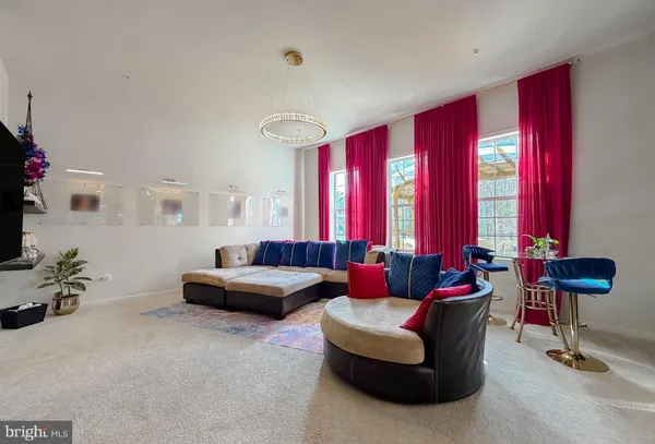a living room with furniture and floor to ceiling window