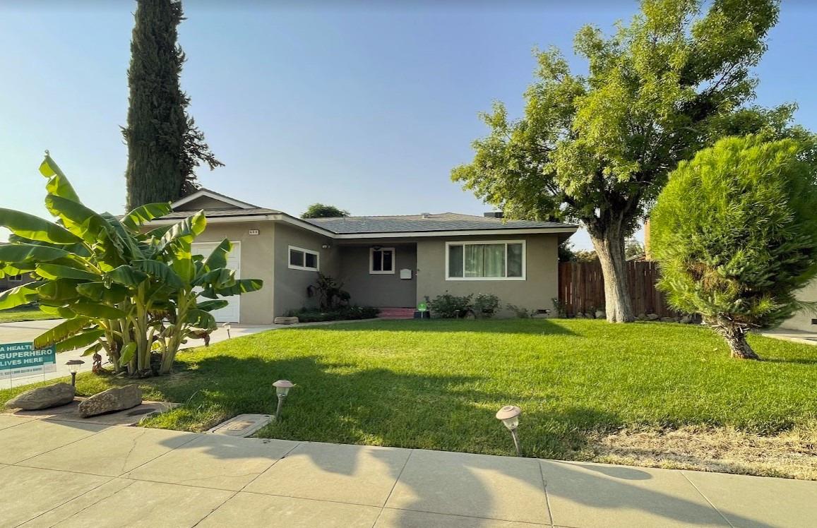 698 West Ashcroft Avenue Clovis, CA 93612 - Photo 1 of 11 a front view of a house with a garden and trees