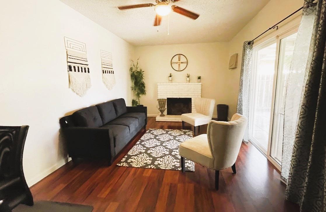 698 West Ashcroft Avenue Clovis, CA 93612 - Photo 3 of 11 a living room with furniture and a fireplace