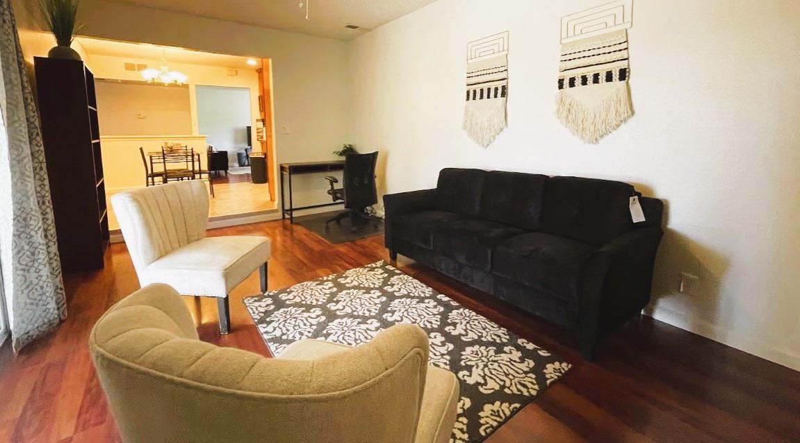 698 West Ashcroft Avenue Clovis, CA 93612 - Photo 4 of 11 a living room with furniture and a floor to ceiling window