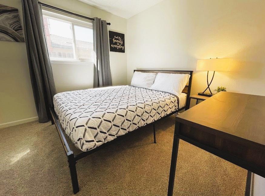 698 West Ashcroft Avenue Clovis, CA 93612 - Photo 9 of 11 a bedroom with a bed and window