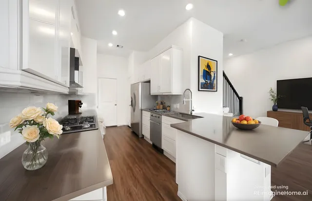 a kitchen with a sink appliances and cabinets