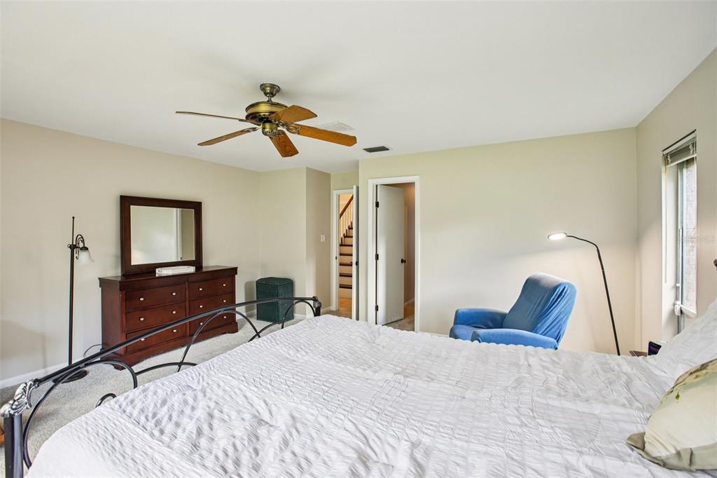 19254 Blount Road Lutz, FL 33558 - Photo 19 of 34 a bedroom with a bed and a chandelier