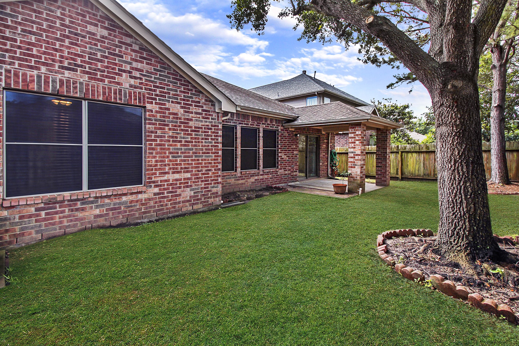 1814 Parkfair Court Katy, TX 77450 - Photo 32 of 36 Back yard has a covered patio. Nice mature trees for extra shade.