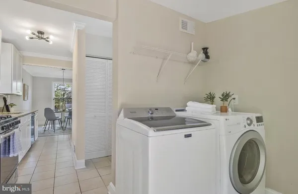 a utility room with cabinets washer and dryer