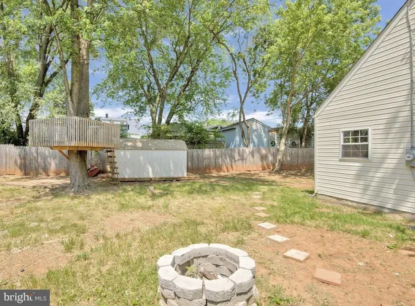 a backyard of a house with barbeque oven