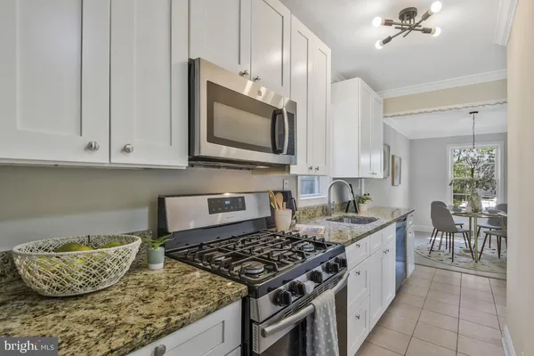 a kitchen with a stove a sink and cabinets