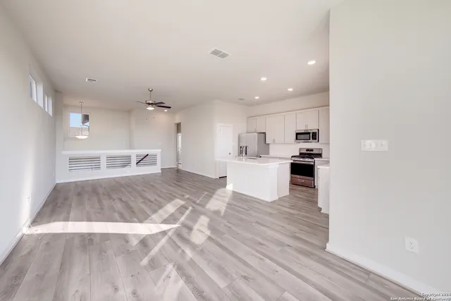 a view of kitchen with sink microwave and refrigerator