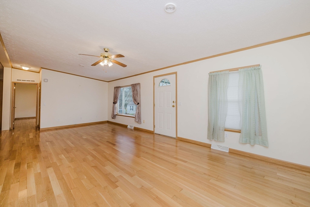 18 Mockingbird Lane Tiverton, RI 02878 - Photo 11 of 32 a view of an empty room with wooden floor