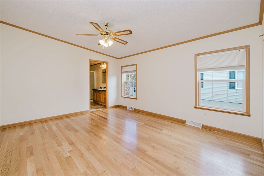 18 Mockingbird Lane Tiverton, RI 02878 - Photo 15 of 32 a view of an empty room with wooden floor and a window