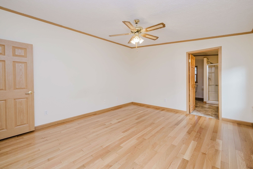18 Mockingbird Lane Tiverton, RI 02878 - Photo 17 of 32 a view of an empty room with wooden floor and a ceiling fan