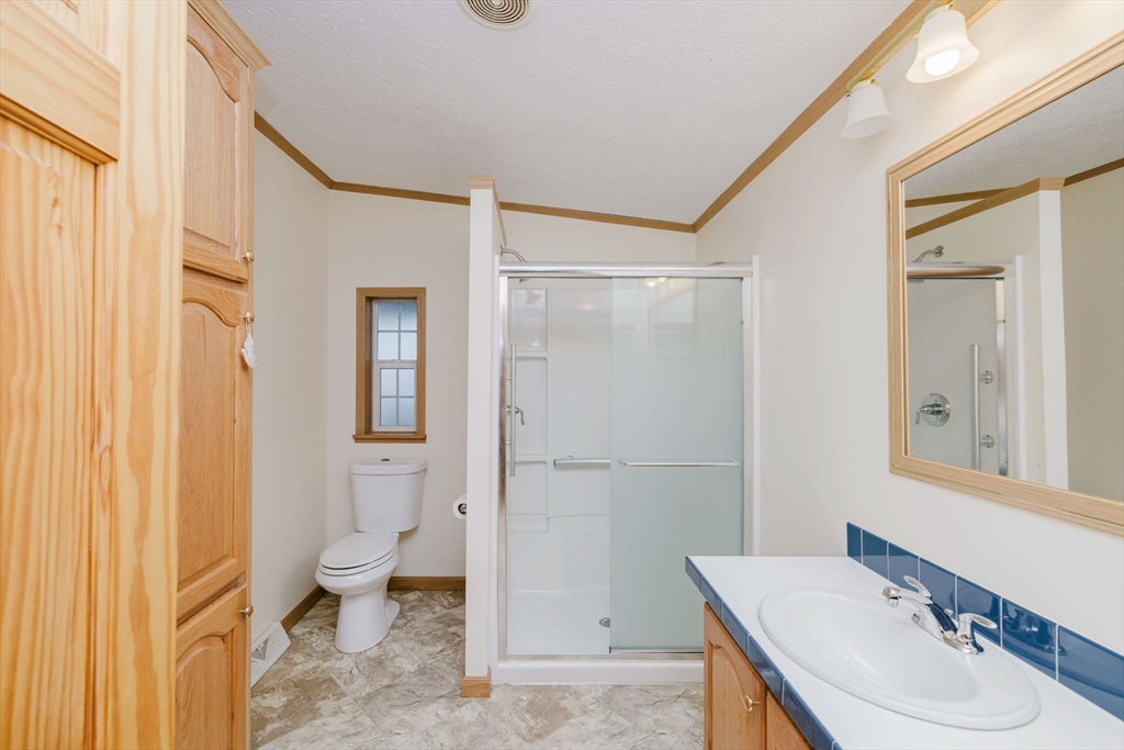 18 Mockingbird Lane Tiverton, RI 02878 - Photo 19 of 32 a bathroom with a sink toilet and shower