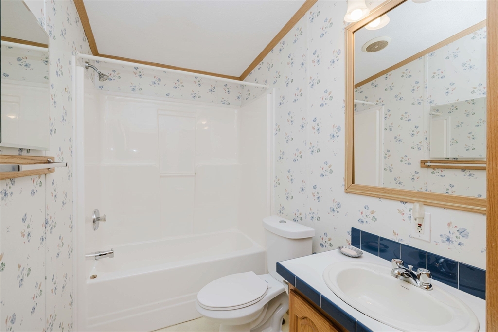 18 Mockingbird Lane Tiverton, RI 02878 - Photo 20 of 32 a bathroom with a sink toilet and shower
