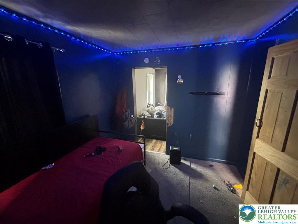 3404 North Ruch Street Whitehall, PA 18052 - Photo 22 of 36 A well-lit bedroom provides a cozy retreat, featuring a bed and easy access to an adjoining space.
