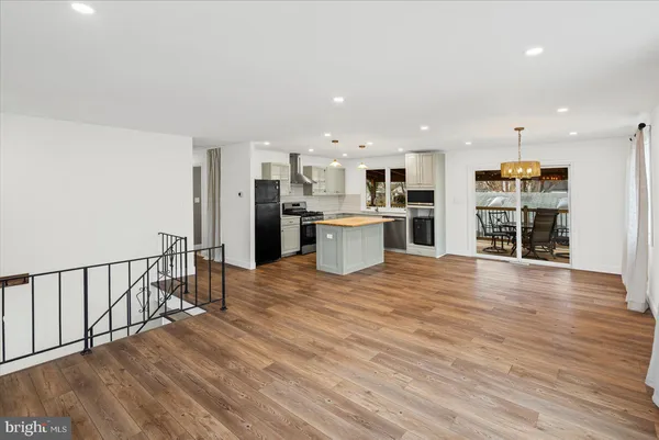 a view of a kitchen with a sink and a refrigerator
