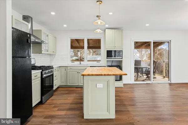 a kitchen with a sink stove and refrigerator