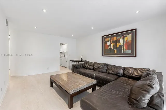 a living room with furniture and a night stand