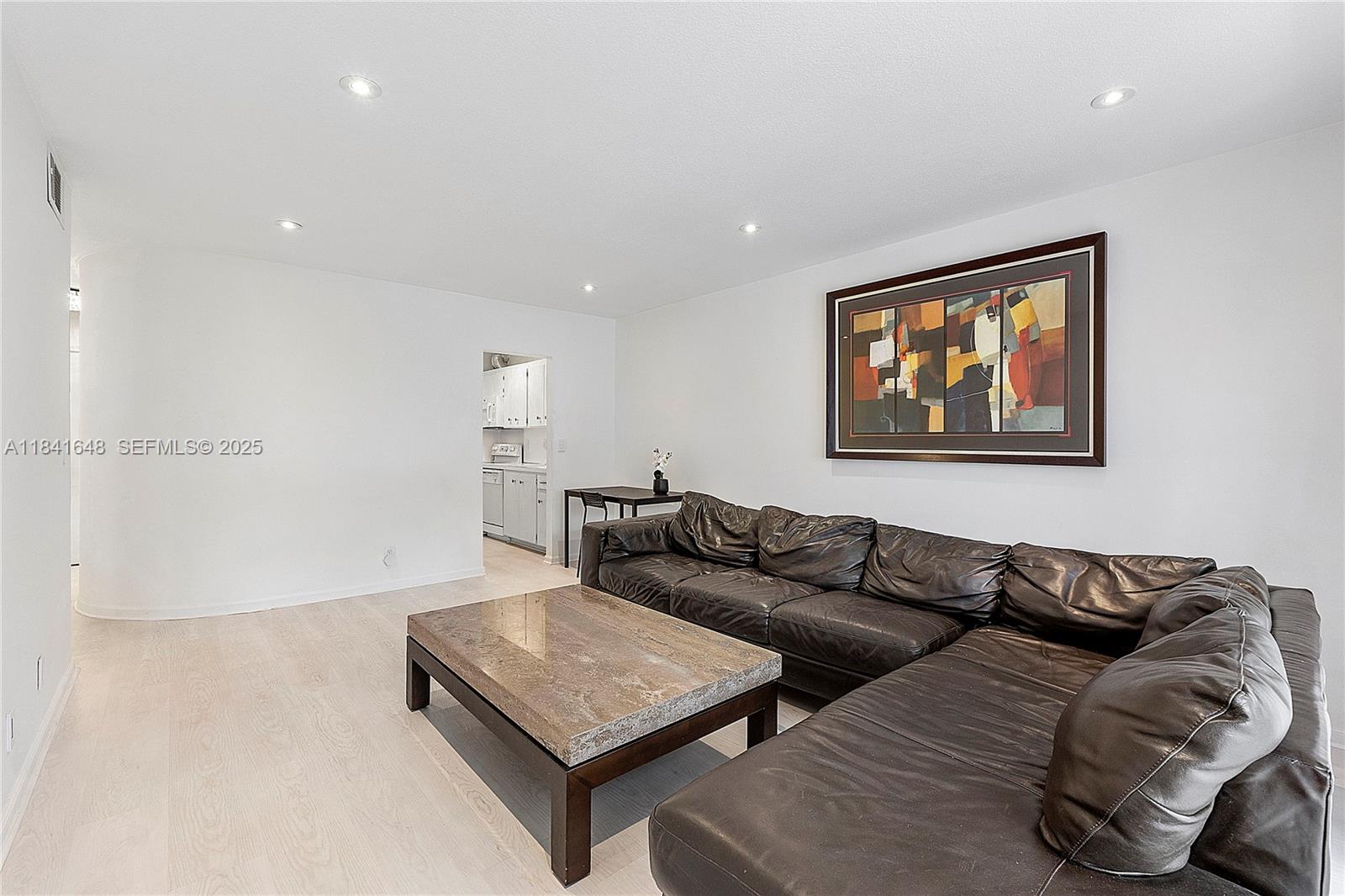 a living room with furniture and a night stand
