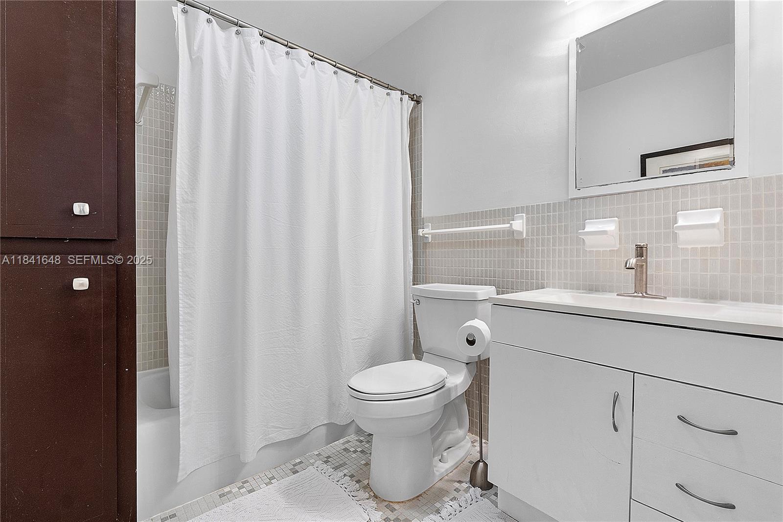 2180 Northeast 67th Street, Unit 728 Fort Lauderdale, FL 33308 - Photo 14 of 49 a bathroom with a sink a toilet and shower