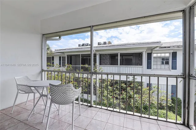 a view of a chair and table in the balcony