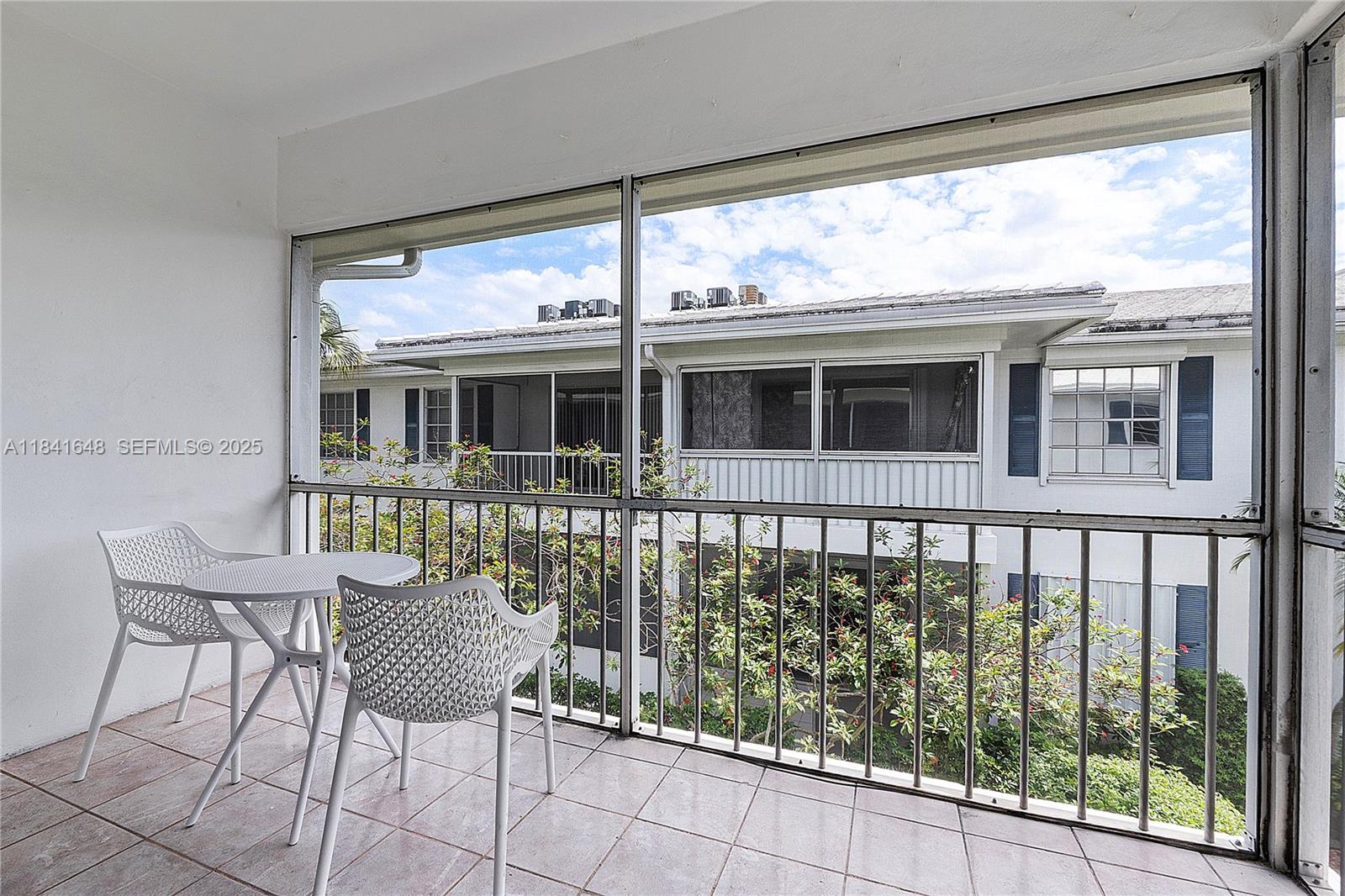 2180 Northeast 67th Street, Unit 728 Fort Lauderdale, FL 33308 - Photo 15 of 49 a view of a chair and table in the balcony