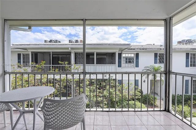 a view of a chair and table on the deck