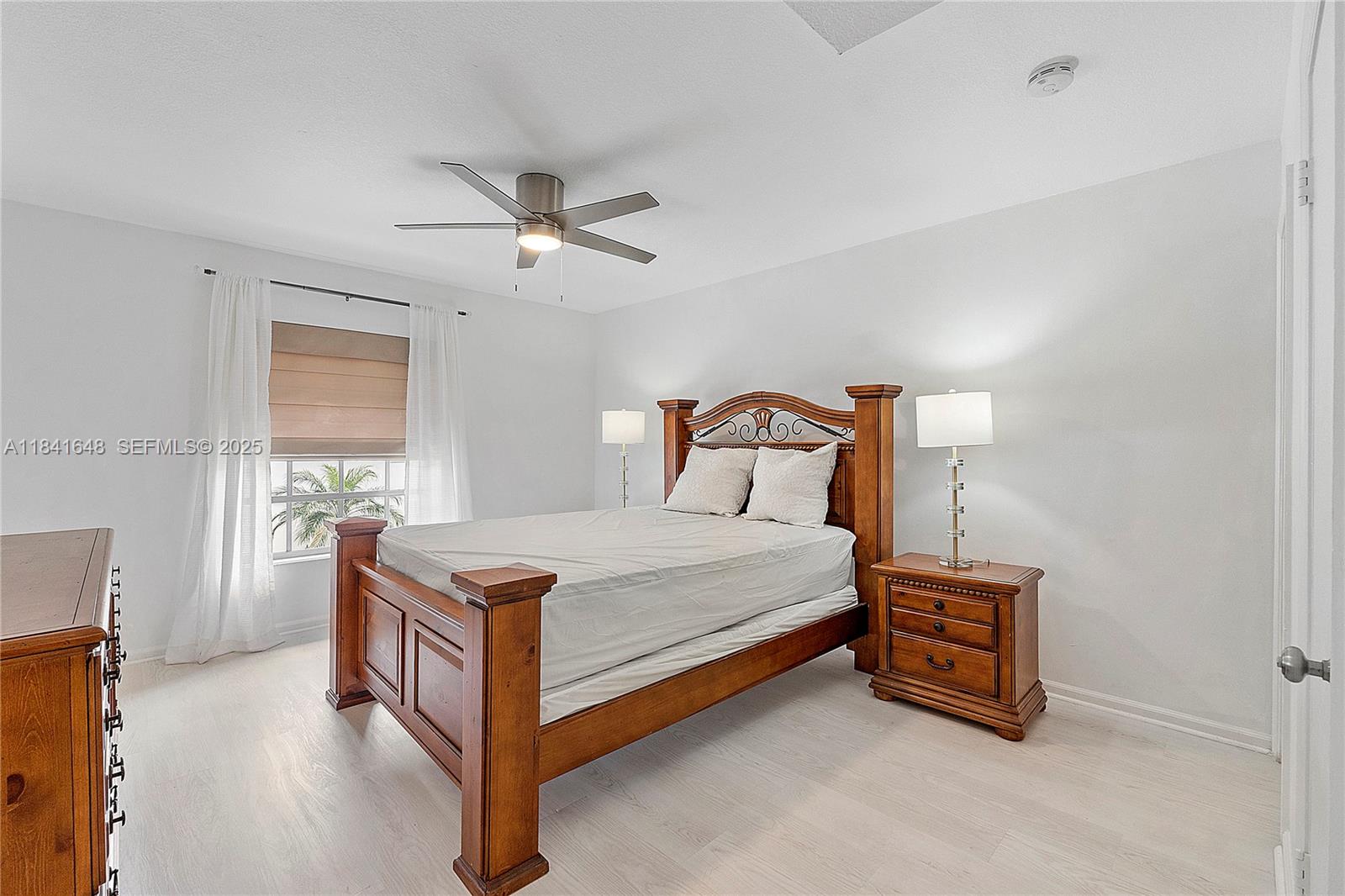 2180 Northeast 67th Street, Unit 728 Fort Lauderdale, FL 33308 - Photo 19 of 49 a bedroom with a bed and a window