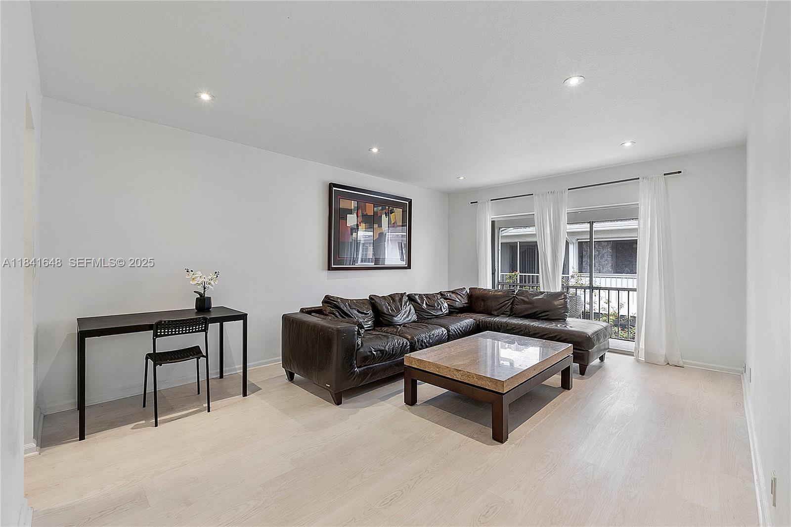 2180 Northeast 67th Street, Unit 728 Fort Lauderdale, FL 33308 - Photo 2 of 49 a living room with furniture and a window