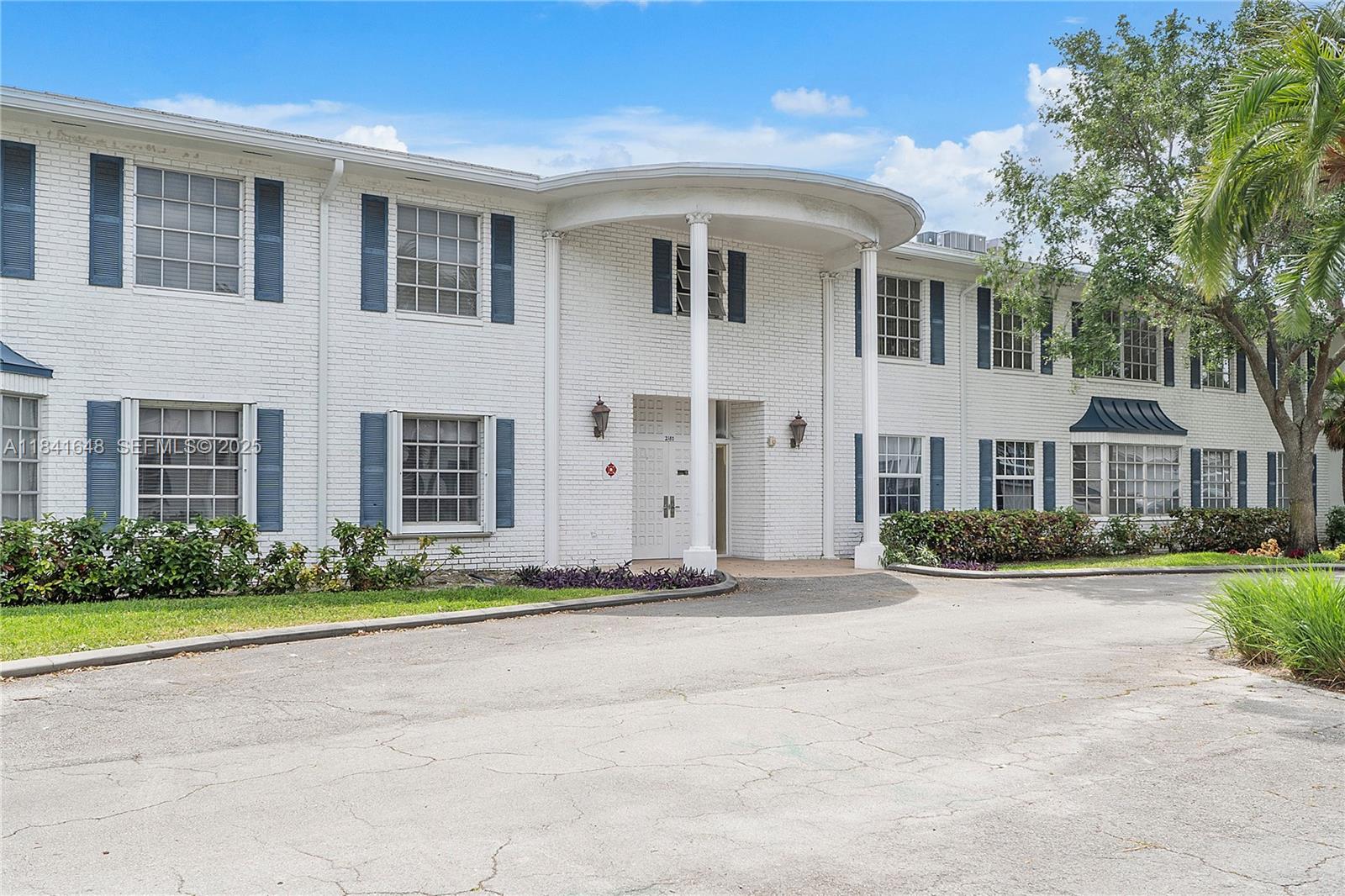 2180 Northeast 67th Street, Unit 728 Fort Lauderdale, FL 33308 - Photo 24 of 49 a front view of a house with a yard