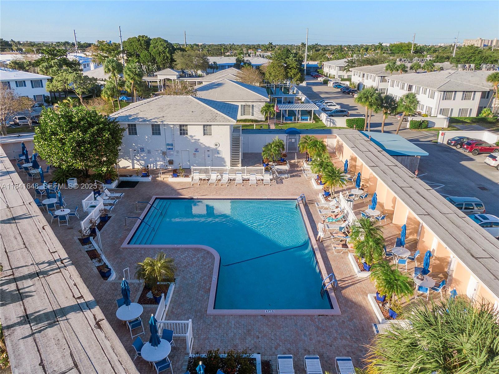 2180 Northeast 67th Street, Unit 728 Fort Lauderdale, FL 33308 - Photo 25 of 49 an aerial view of a house with swimming pool outdoor seating