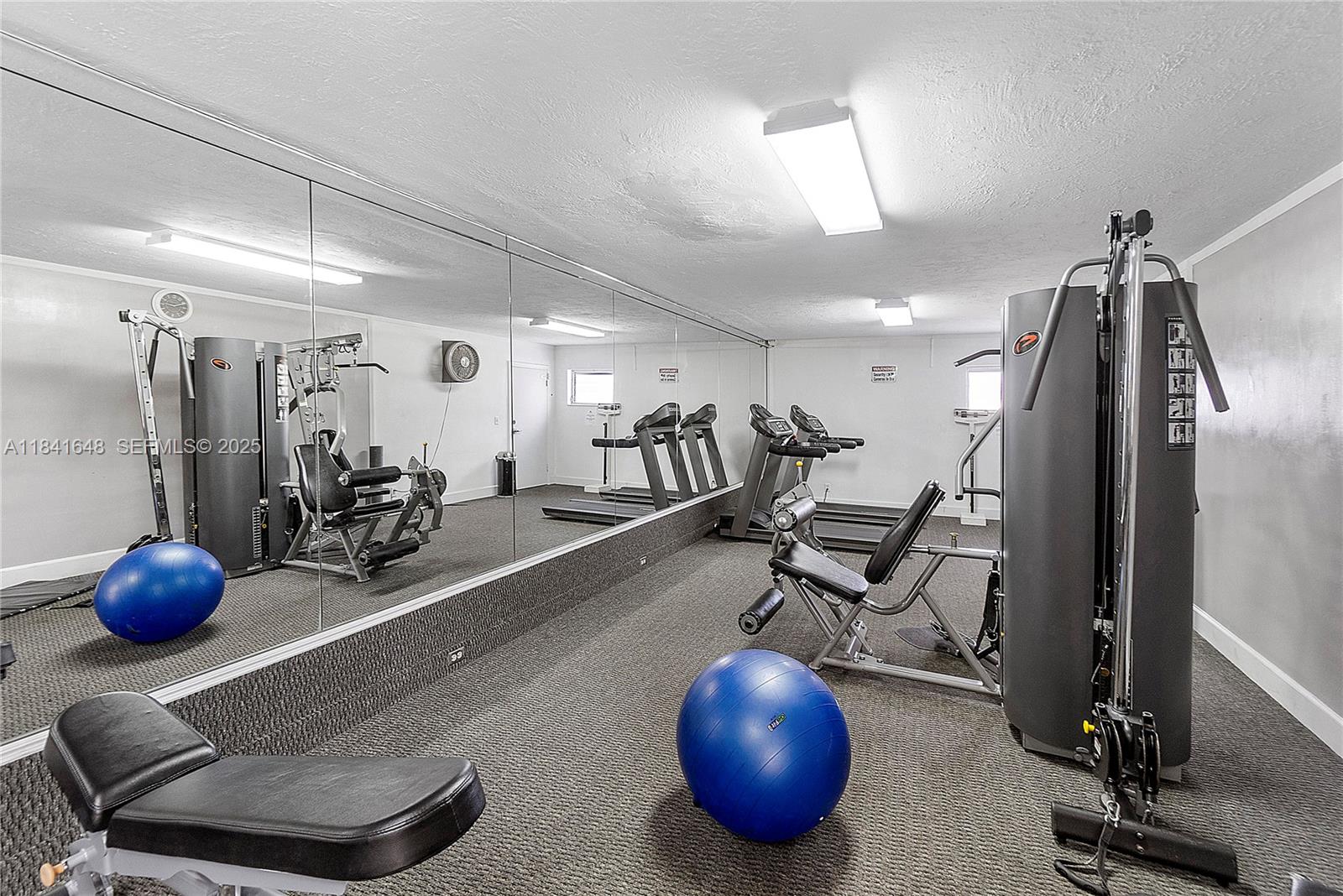 2180 Northeast 67th Street, Unit 728 Fort Lauderdale, FL 33308 - Photo 27 of 49 a view of a room with gym equipment