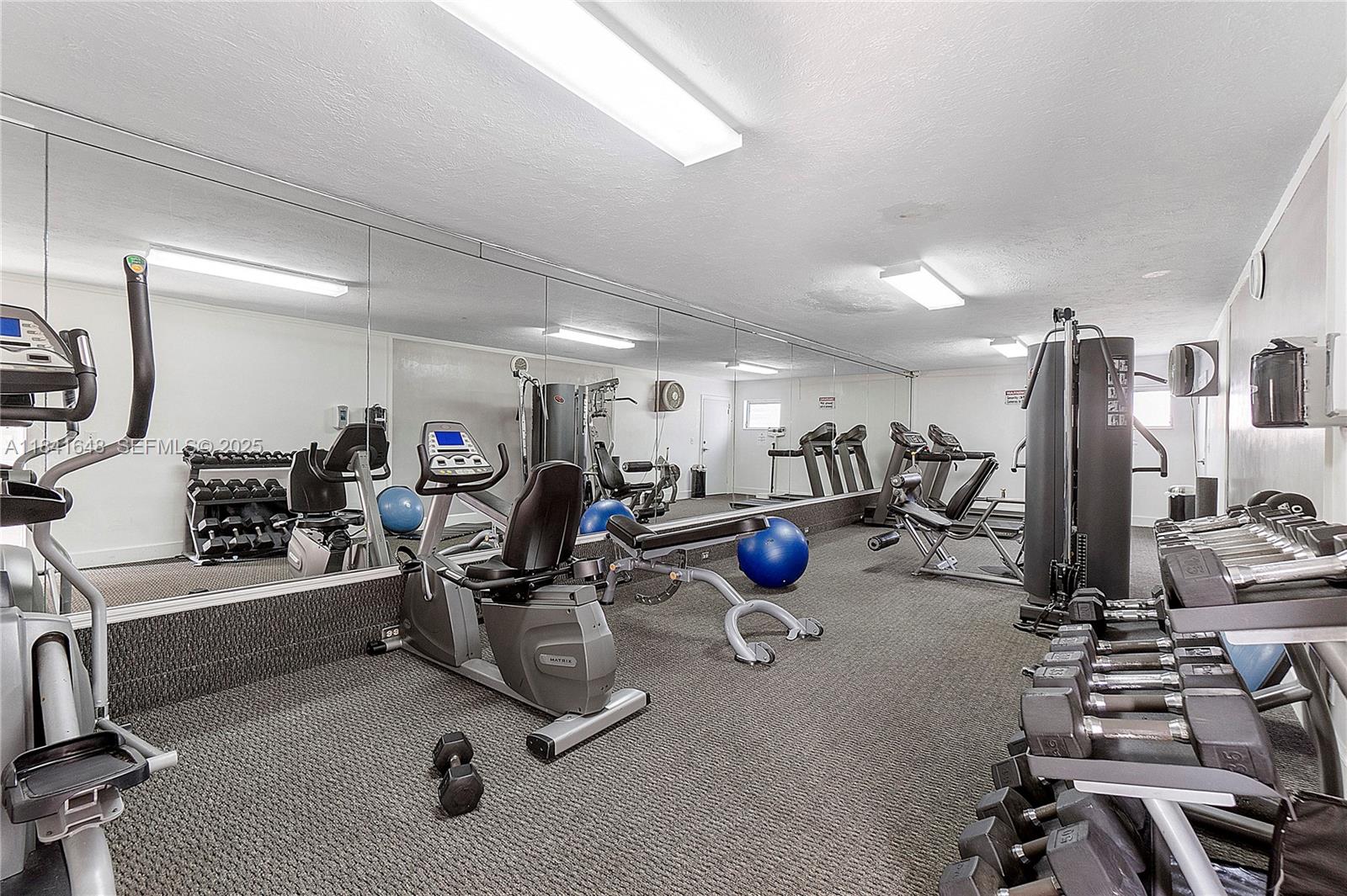 2180 Northeast 67th Street, Unit 728 Fort Lauderdale, FL 33308 - Photo 28 of 49 a view of a room with gym equipment
