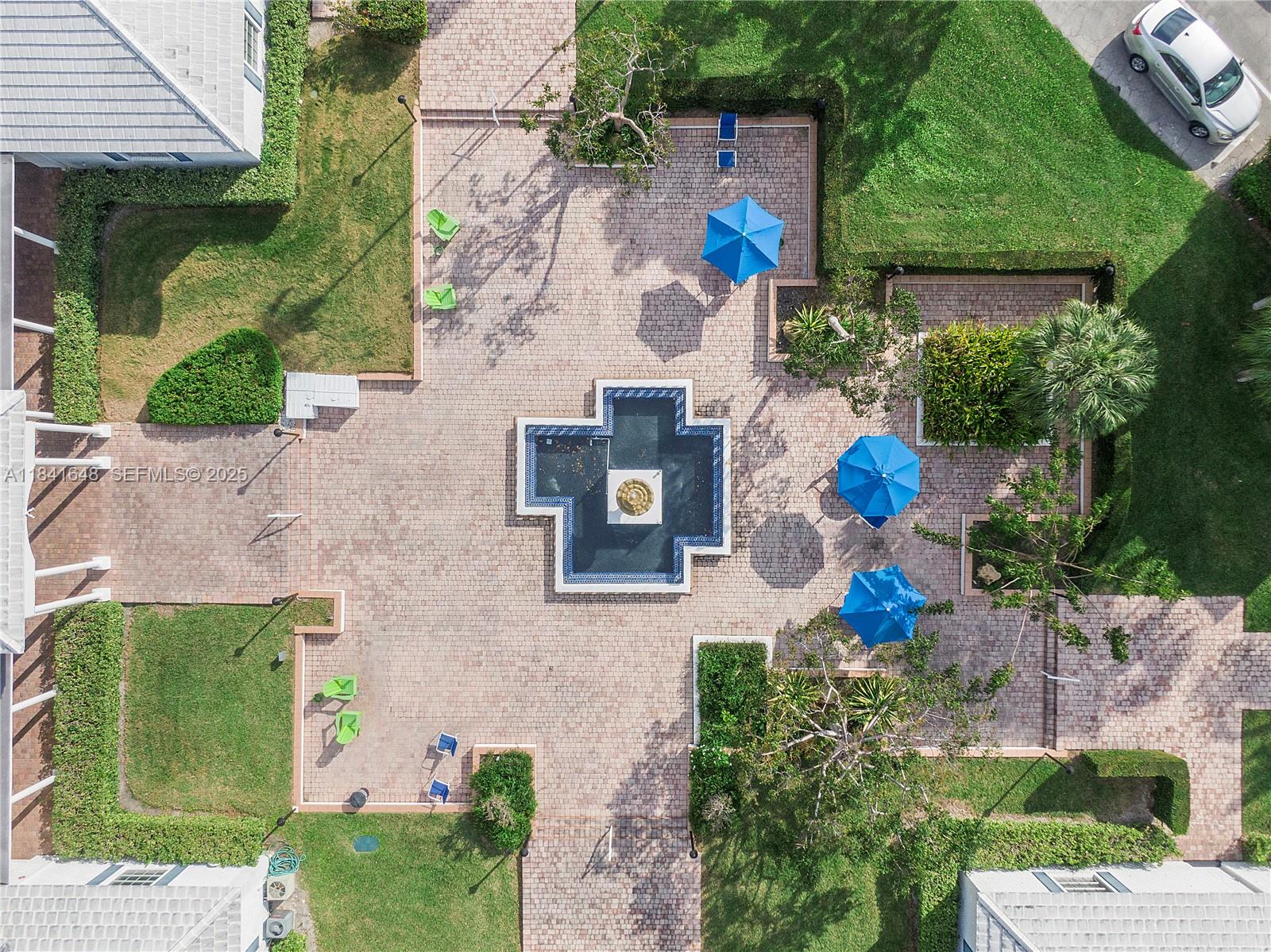 2180 Northeast 67th Street, Unit 728 Fort Lauderdale, FL 33308 - Photo 36 of 49 an aerial view of a house with a yard and potted plants