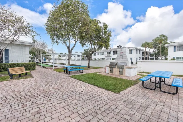 a view of a house with backyard and sitting area