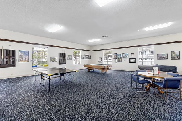 a living room with furniture a rug and a table
