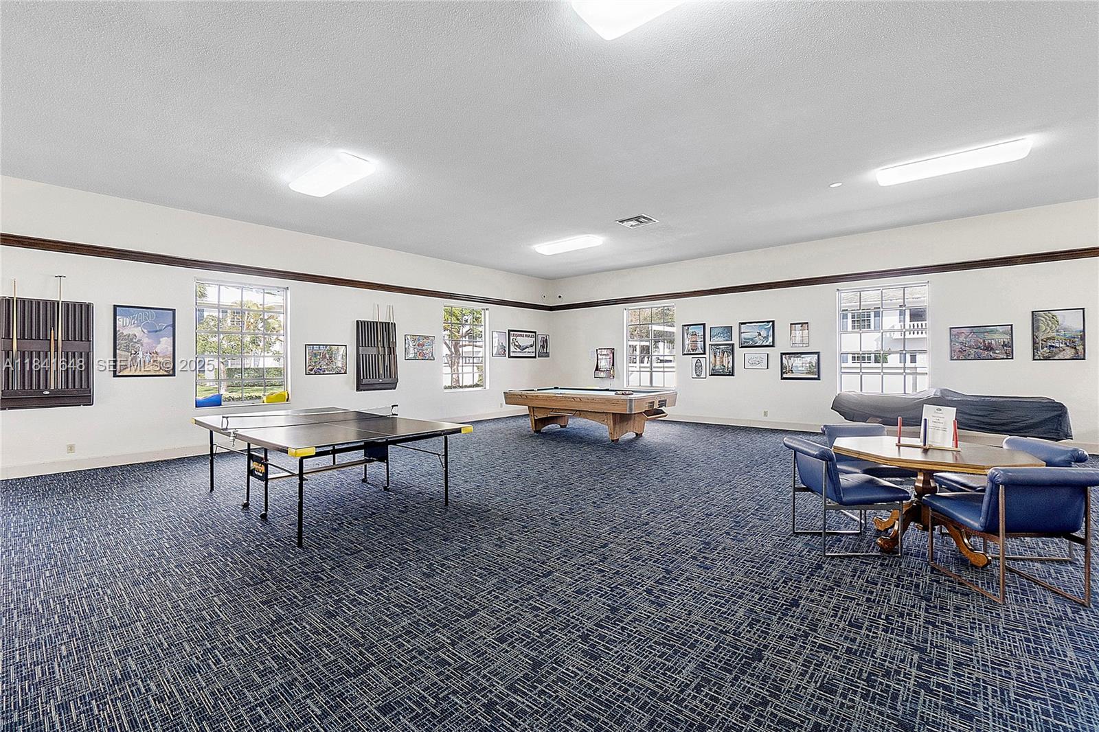 2180 Northeast 67th Street, Unit 728 Fort Lauderdale, FL 33308 - Photo 46 of 49 a living room with furniture a rug and a table