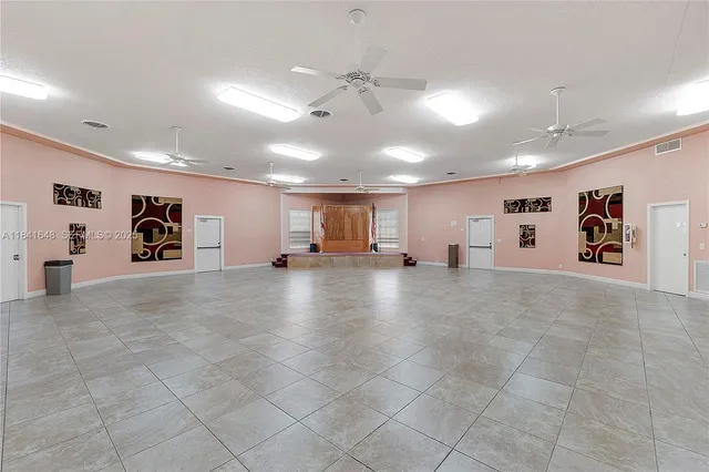a view of a livingroom with furniture and a ceiling fan