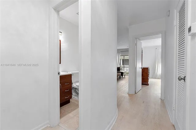 a view of a hallway with wooden shelves