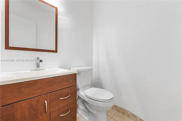 a bathroom with a sink a toilet and mirror